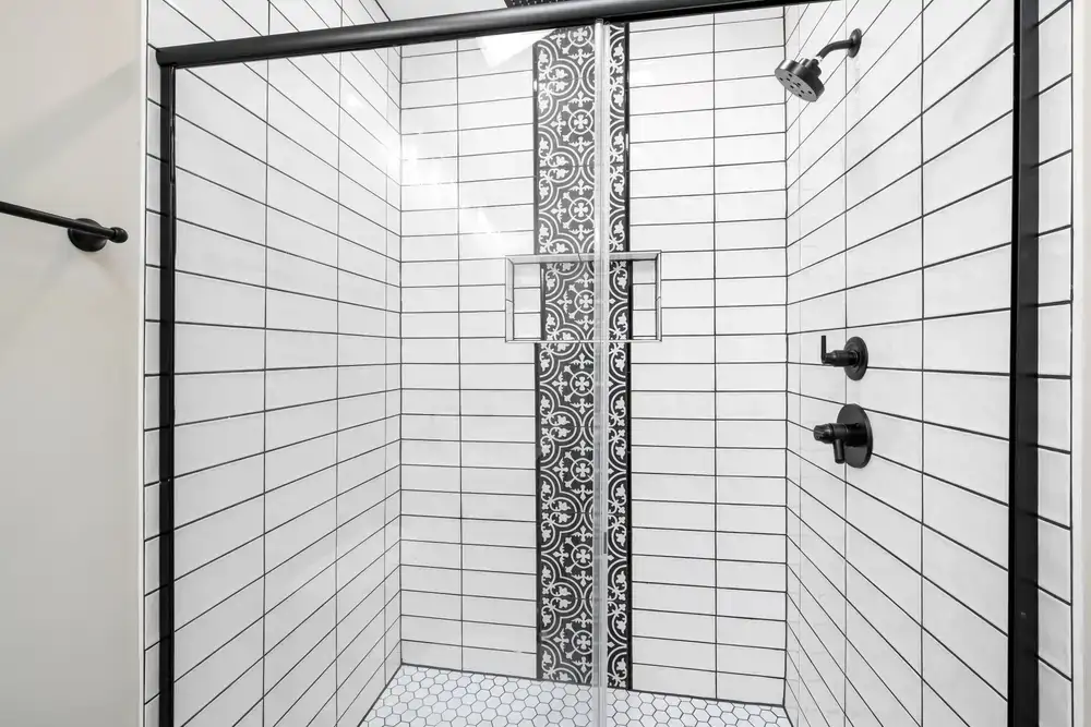 Minimalist glass shower enclosure with matte black fittings