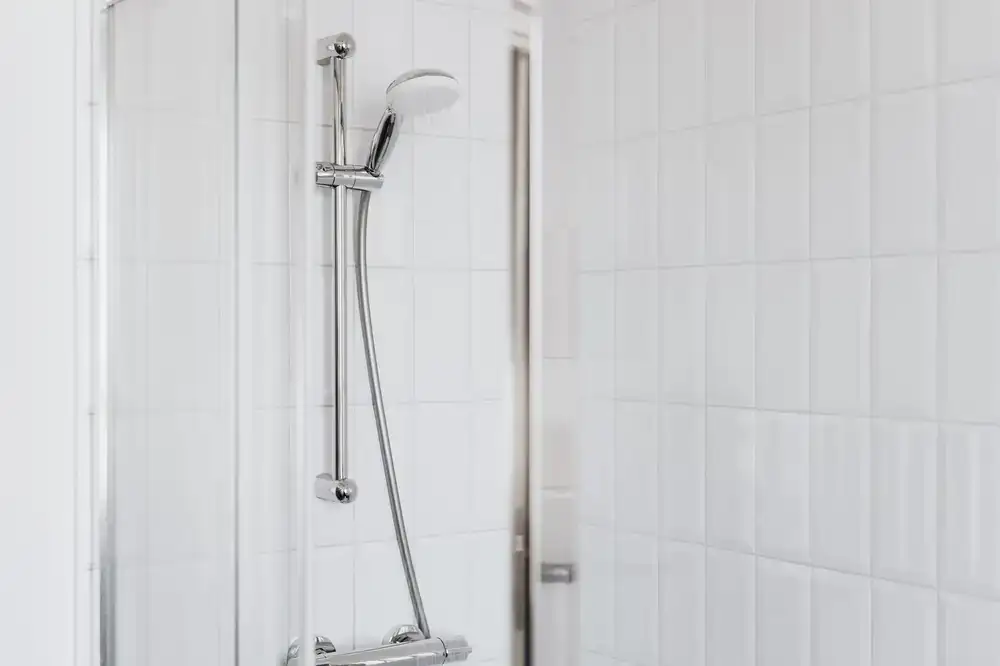 A contemporary bathroom designed with large format tiles and minimalist fixtures