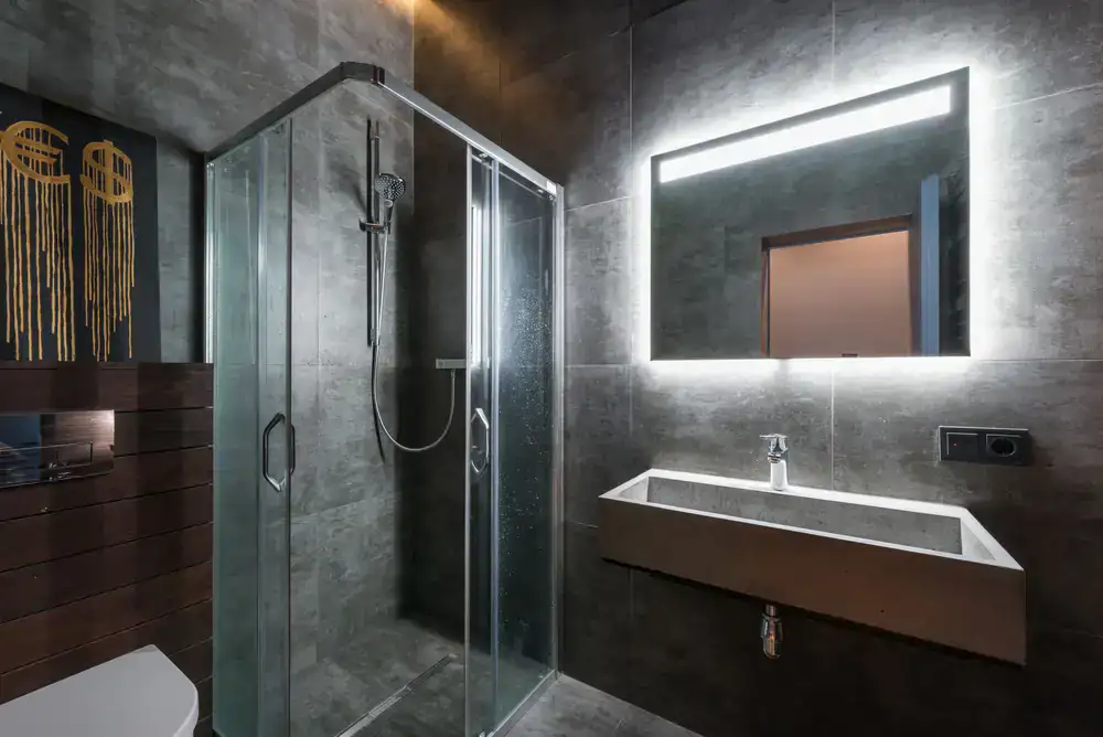 Dark textured bathroom tiles in a wet room setup